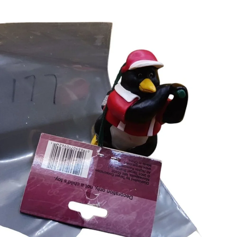 Trim a traditional golfing penguin christmas ornament